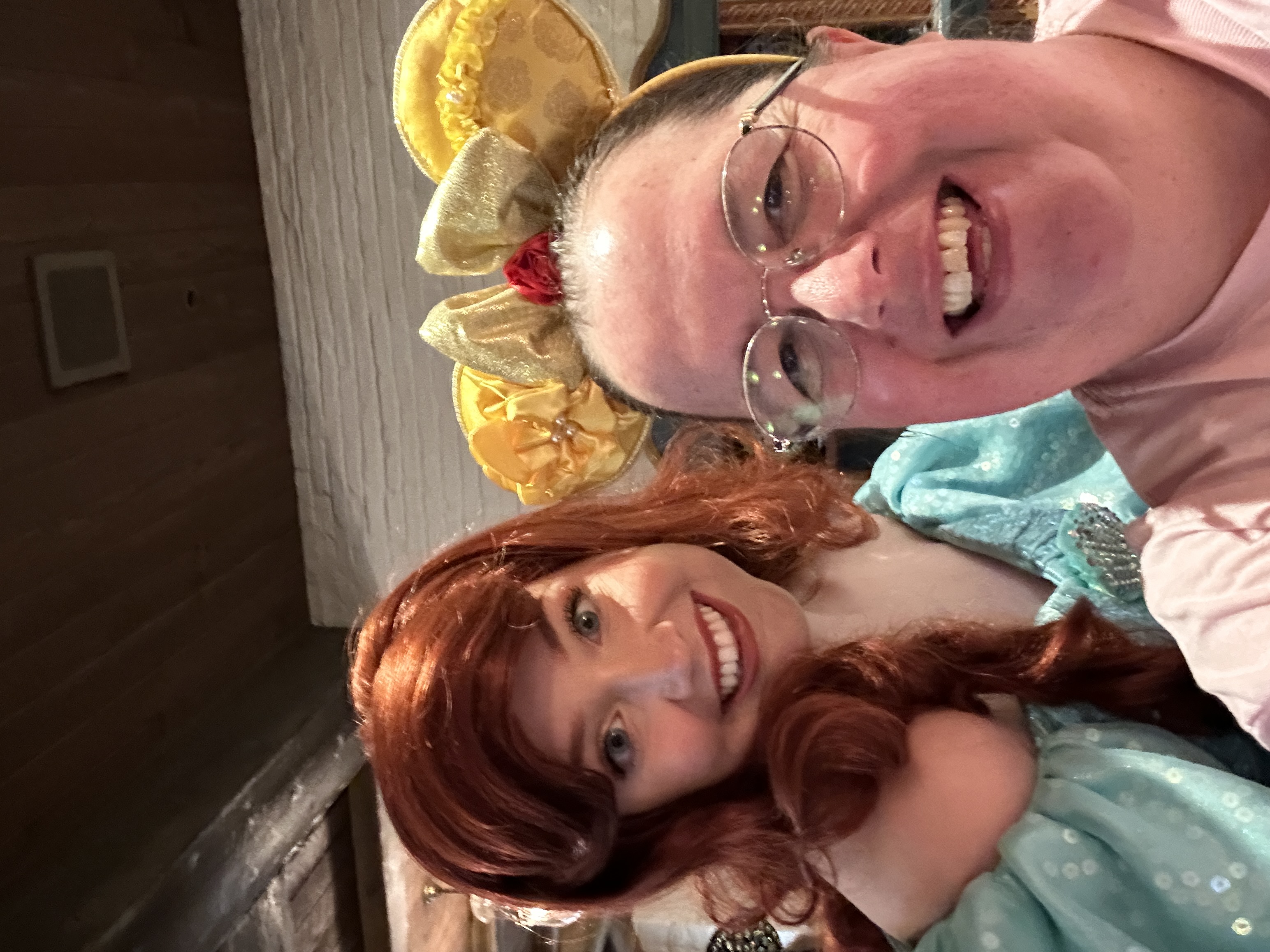 Image shows a lady in yellow mickey muse ears with a disney princess