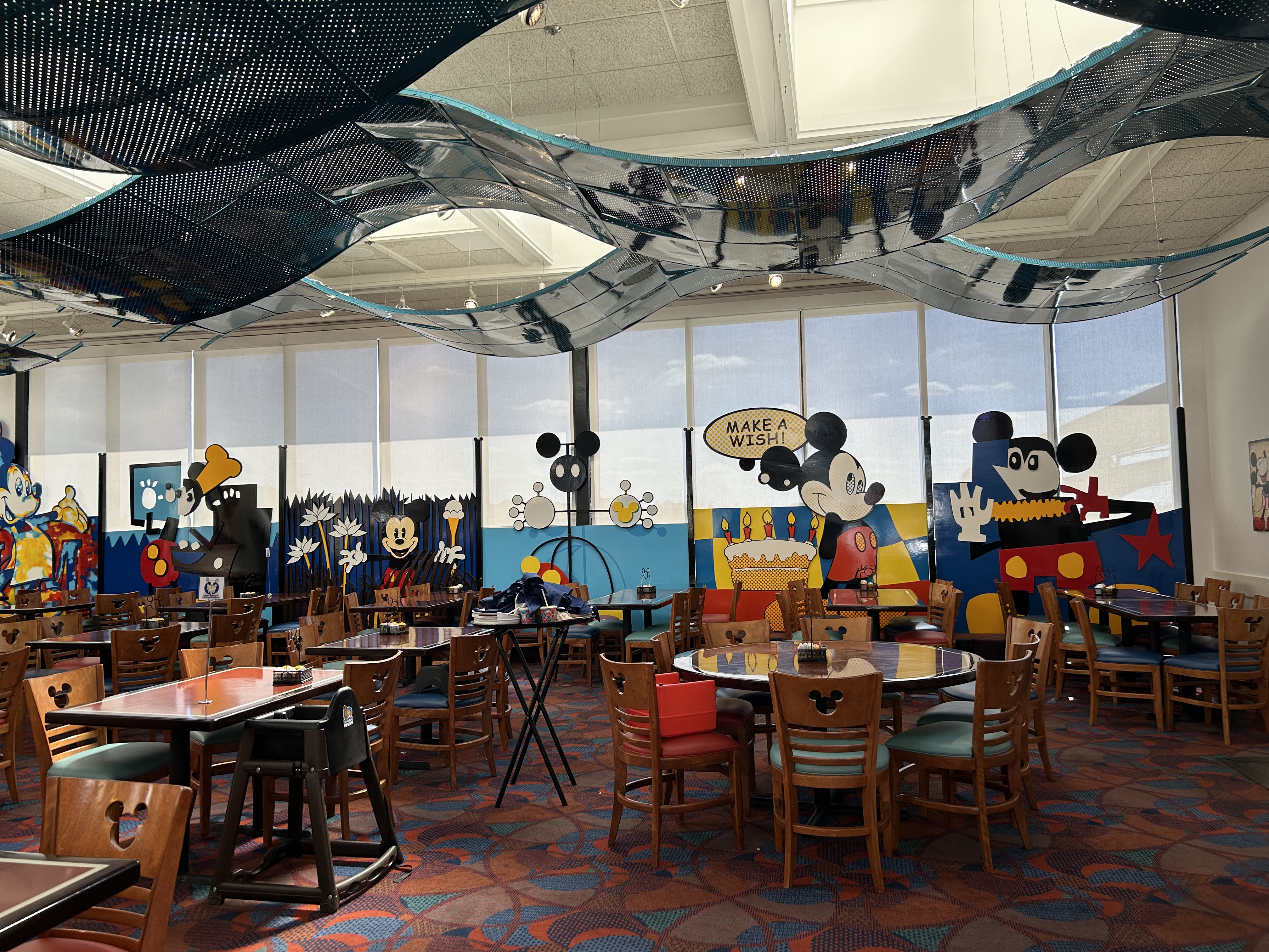 Image shows a themed dining roo with colourful table and chairs