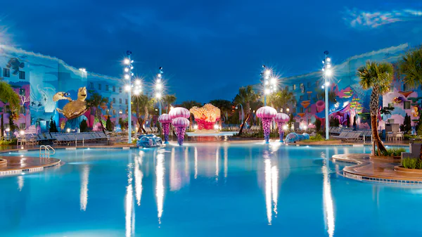 a fun blue swimming pool with large coral statues around