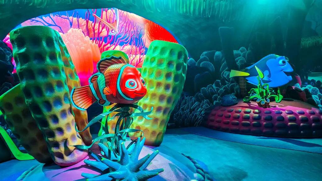 A pretend coral reef with an orange-and-white clownfish and a blue fish with yellow fins