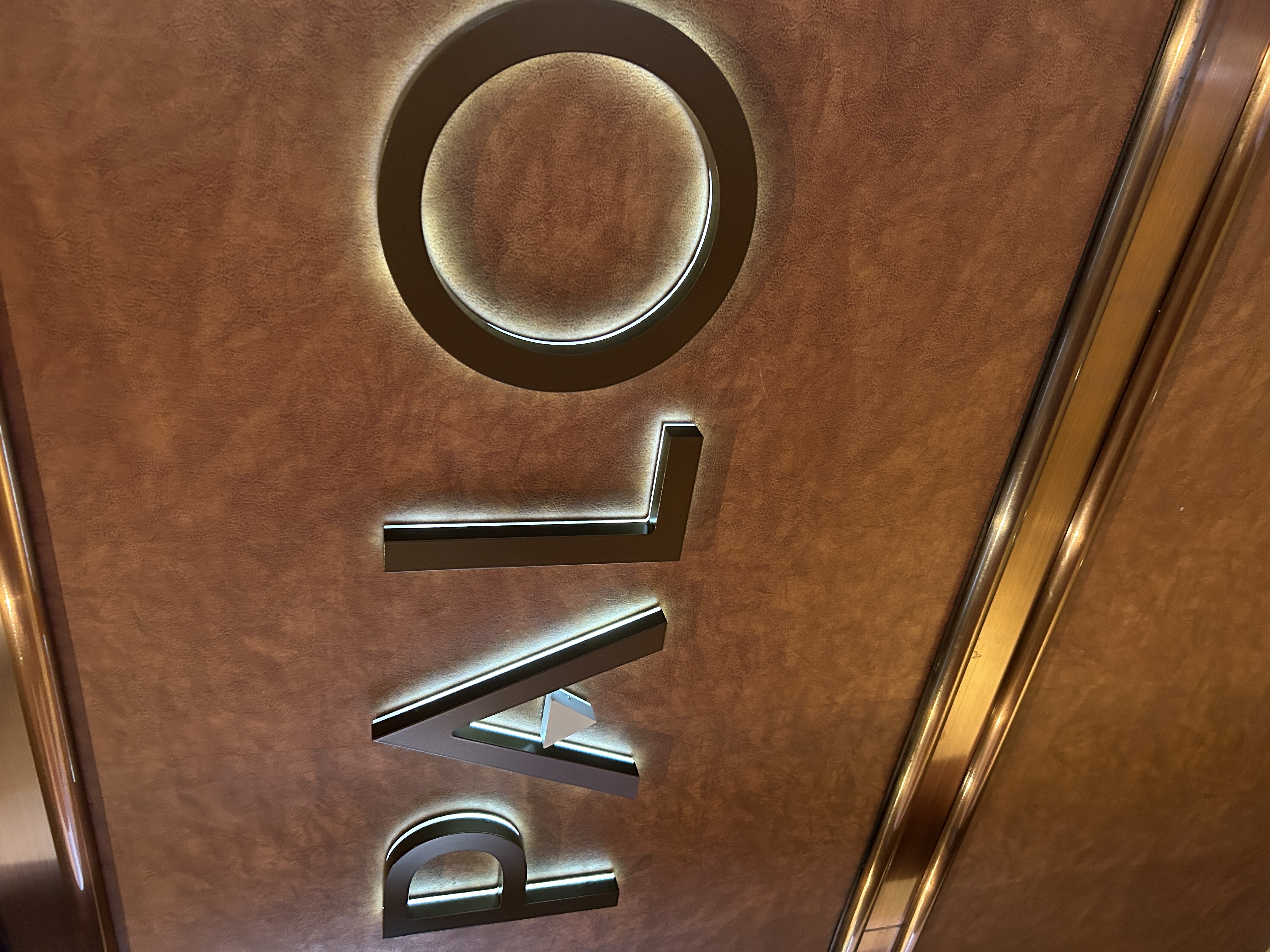 Image shows a stained wooden wall with the word Palo written on it