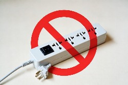 image shows a 4 way power extension bar with a red cross over