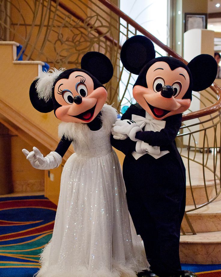 Mickey mouse in a suit Minnie mouse in a white flowing dress