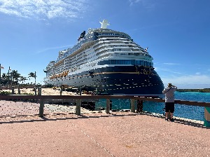 Image shows the Disney Wish docked at Castaway Cay