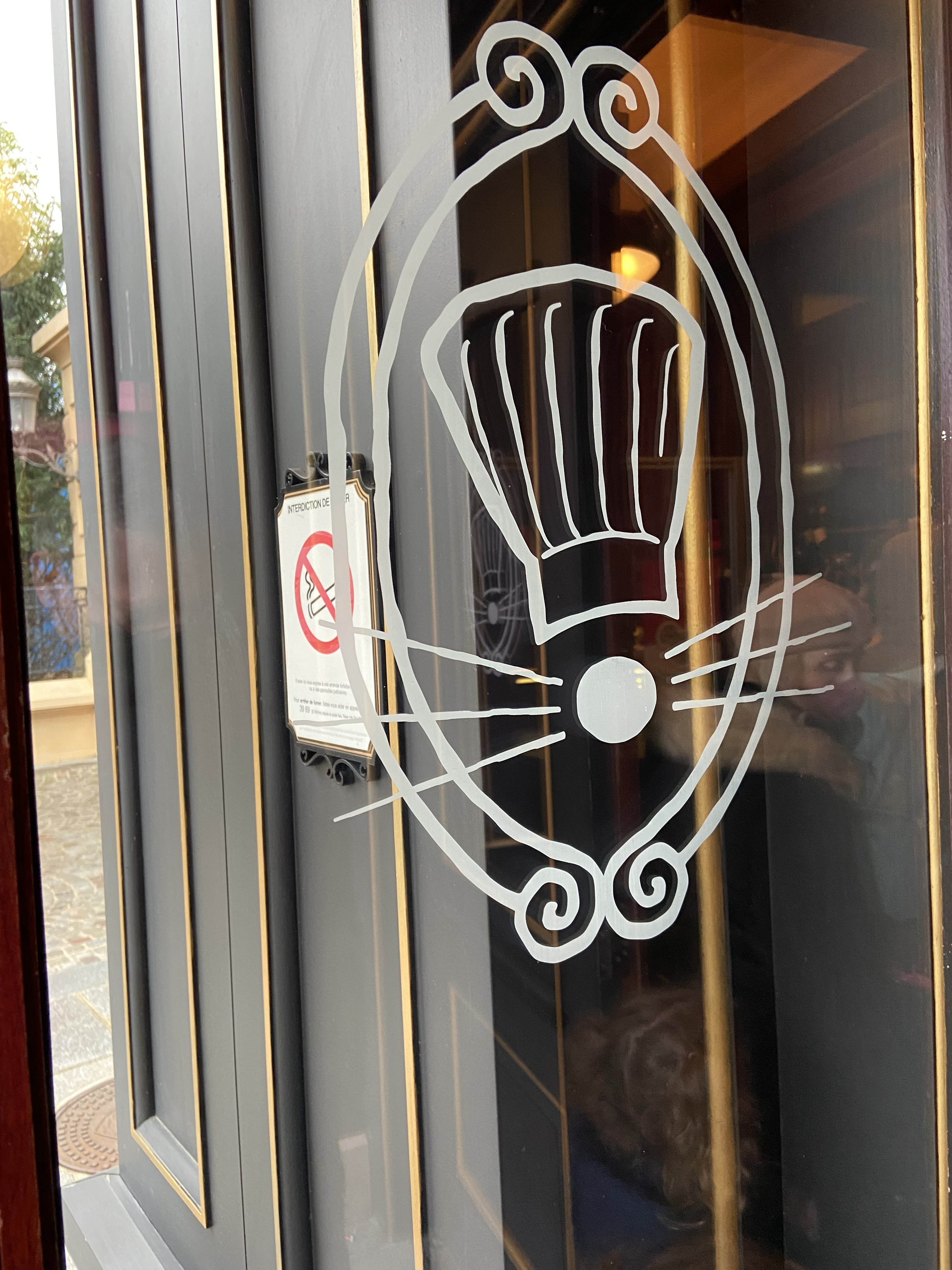 image shows a mouse etched into a glass pane of a door