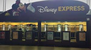Image shows a counter with a sign above featuring Mickey Mouse with the words Disney Express on the sign