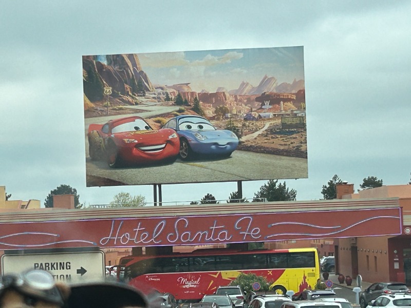the image is of the entrance to the Santa fe hotel showing two cars 