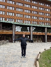 Image shows Mr Disney  standing outside the sequioia lodge 