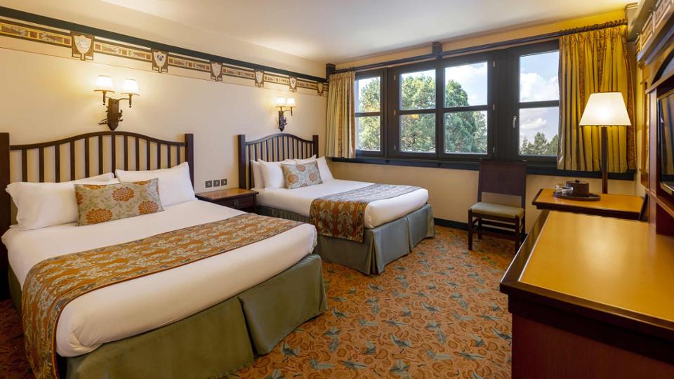 A twin room at Disney's Sequoia Lodge with two beds and themed decor
